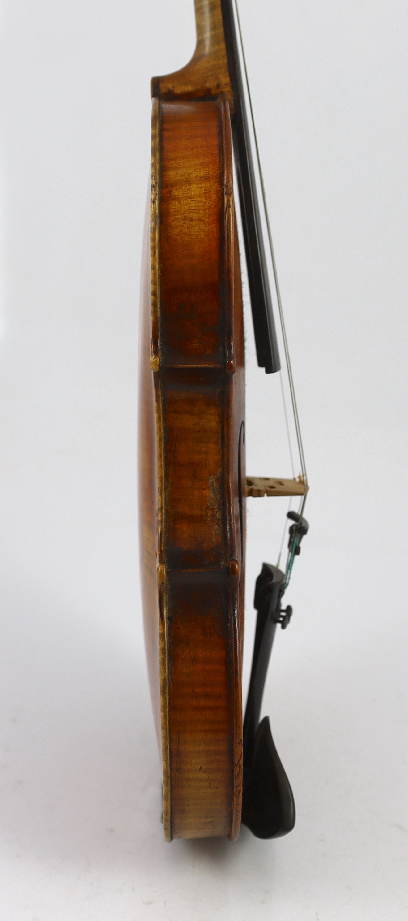 An 18th century violin, labelled ‘New Back by James Carroll, Maker, Manchester 1899’, length of back 36.5cm